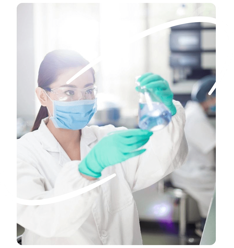 A woman in white lab coat holding a bottle.